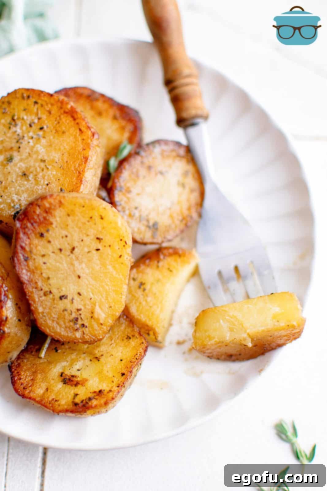 Golden Melt-Away Potatoes 8 Stacked Melting Potatoes on plate with potato on fork.