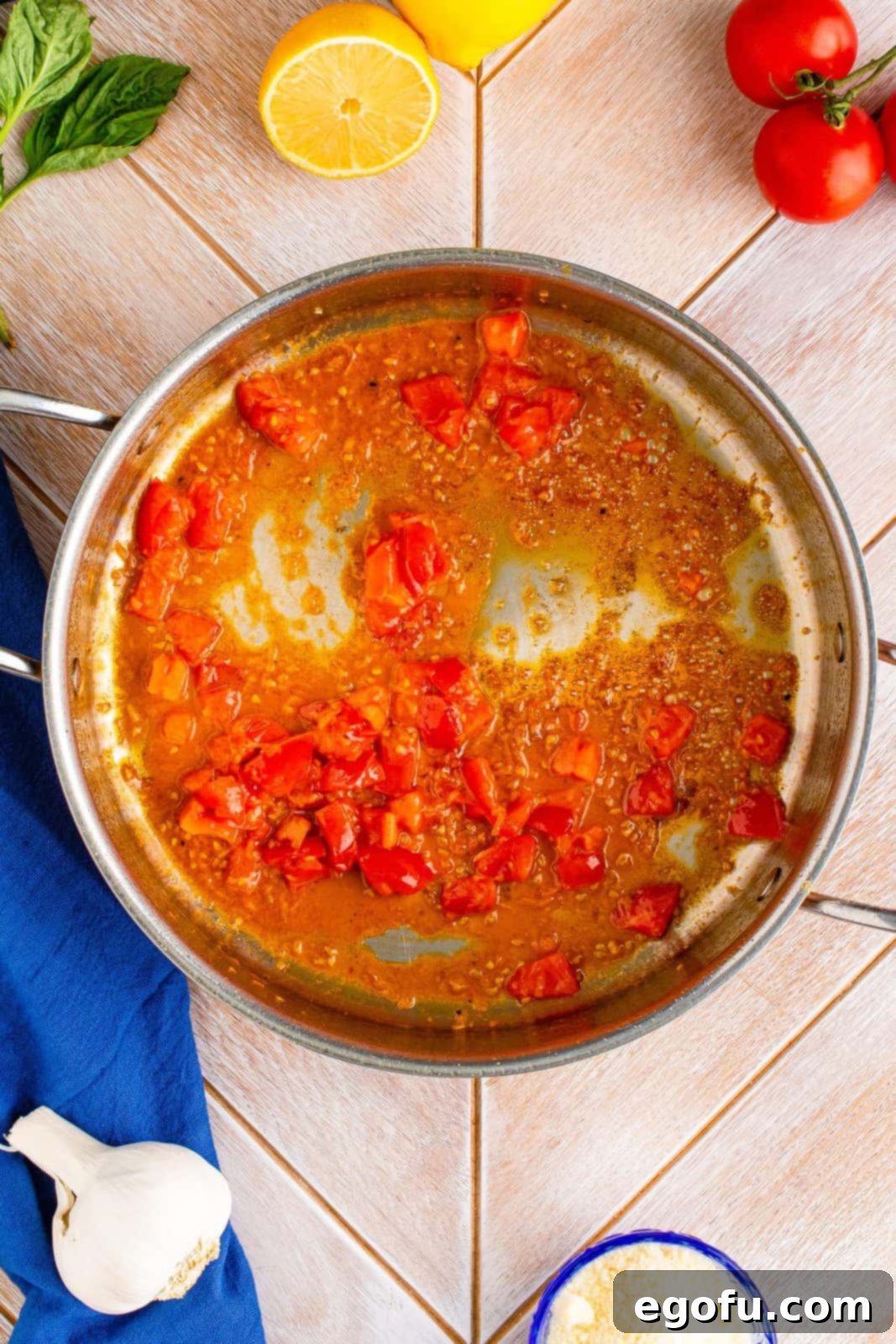 Butter, garlic, tomatoes and flour stirred together in pan.