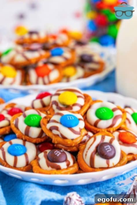 A plate with a pile of Hershey Kiss Pretzels