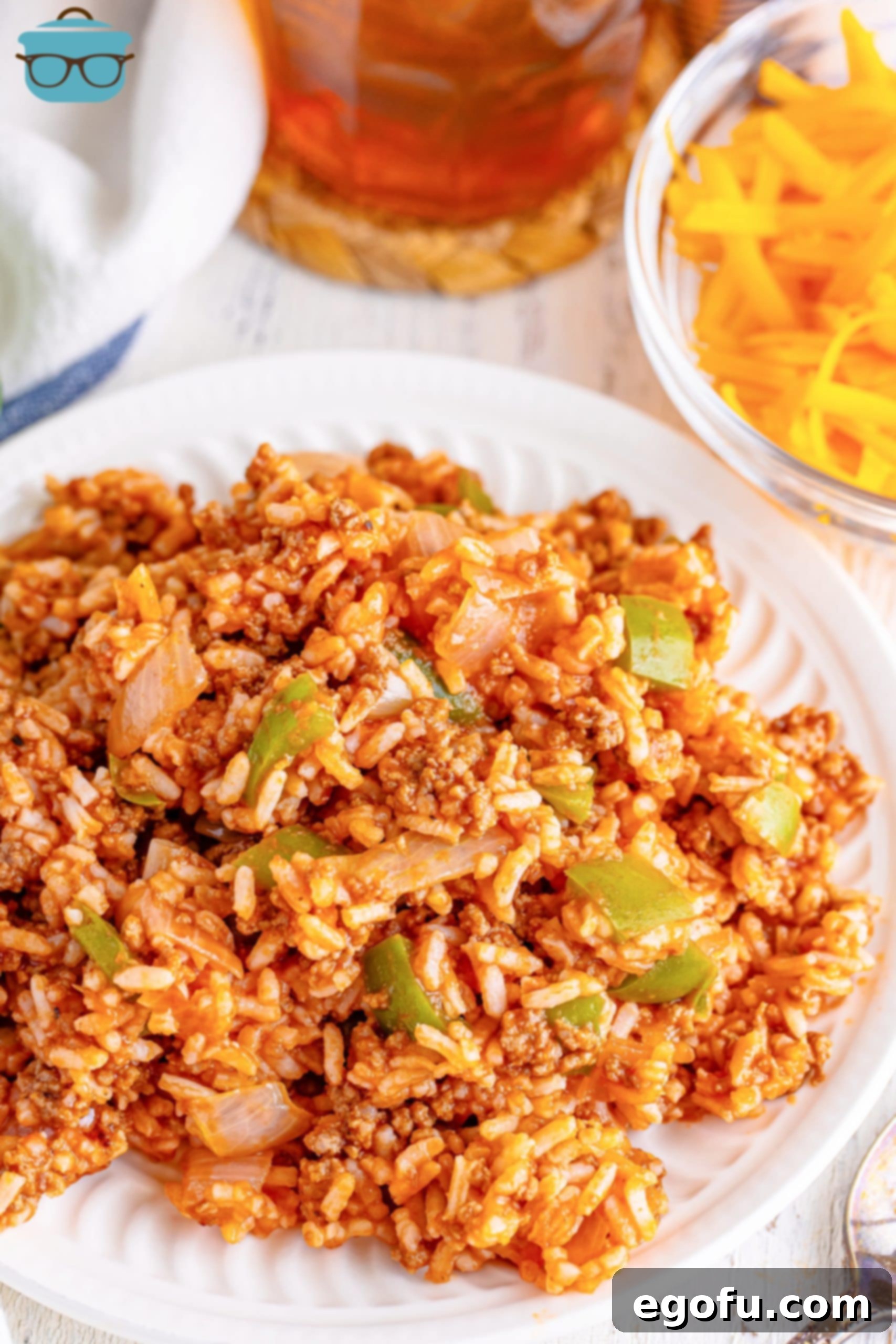 Homemade Spanish Rice 2 A white plate of Spanish Rice, garnished with fresh cilantro.