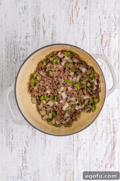 Homemade Spanish Rice 8 Ground beef and veggies in a pot.