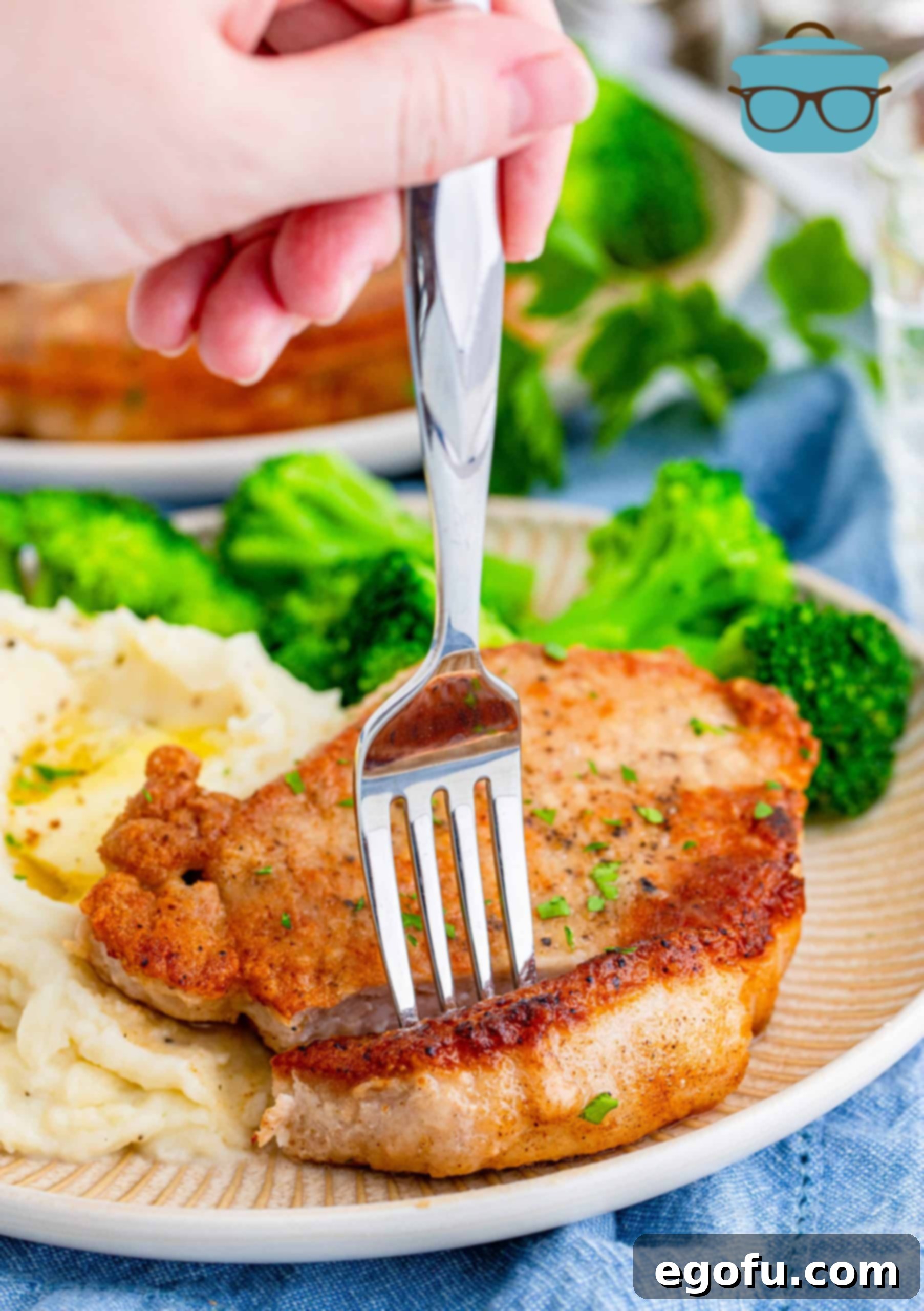 fork inserted to a pork chop.