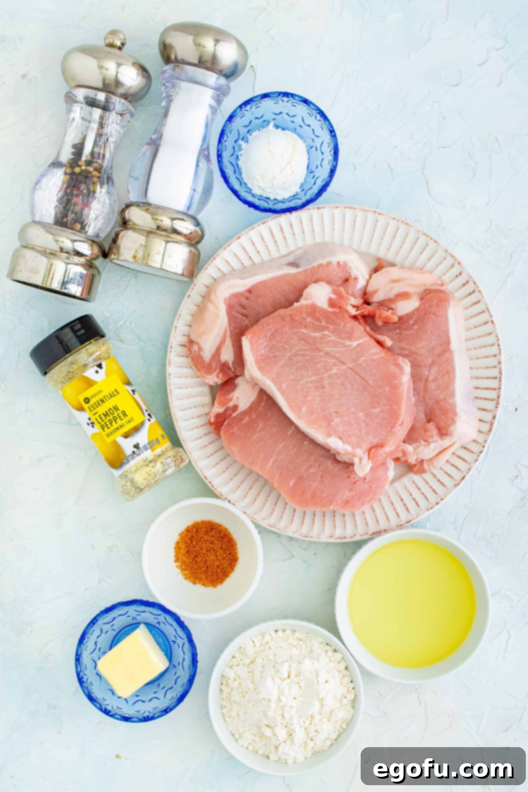 Ingredients for Pan Fried Pork Chops: boneless pork chops, vegetable oil, salted butter, all-purpose flour, corn starch, lemon pepper seasoning, cajun seasoning, salt and pepper