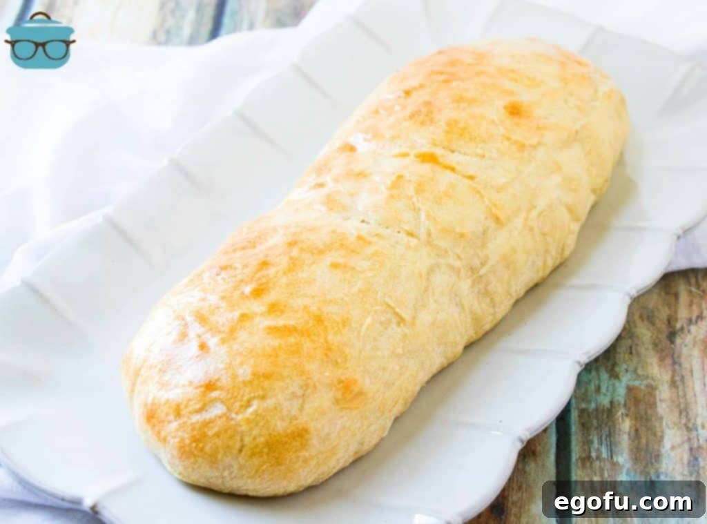 Effortless French Bread Baked Your Way 2 roll of homemade French bread on a white platter.