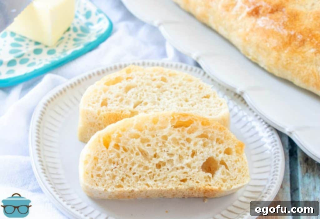 Effortless French Bread Baked Your Way 3 Easy Homemade French Bread, sliced on a plate with butter pictured in the background.