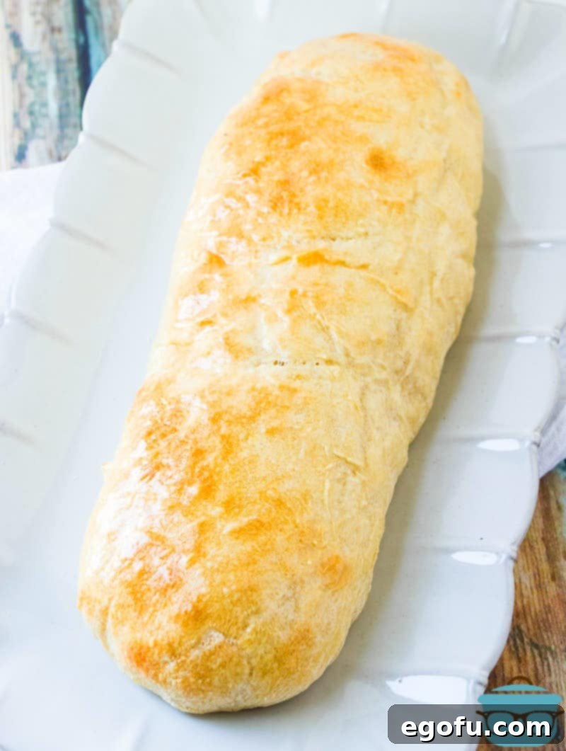 Effortless French Bread Baked Your Way 8 French Bread, fully baked on a white serving platter.