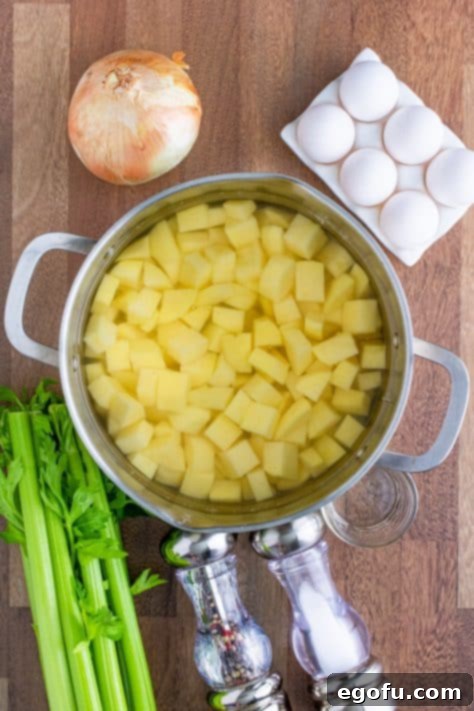 Diced Yukon gold potatoes soaking in a large pot of cold water, ready for boiling.
