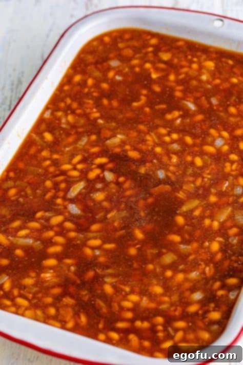 Hearty Comfort Baked Beans 13 A casserole dish with Baked Beans.