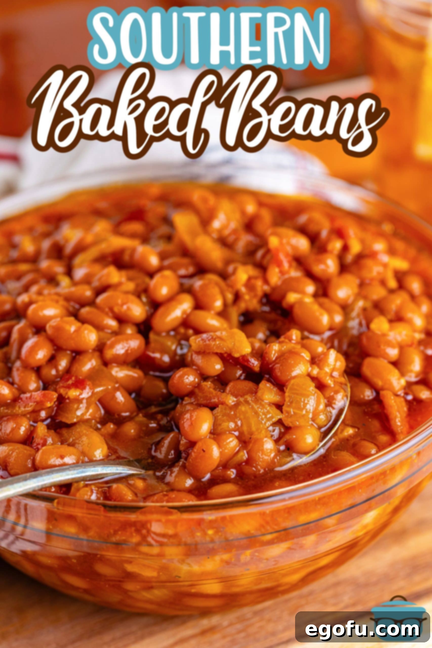 Hearty Comfort Baked Beans 3 A spoon in a large bowl of Southern Baked Beans.