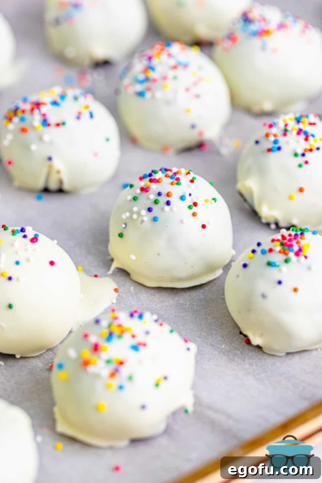 fully coated cookie balls on a baking tray.