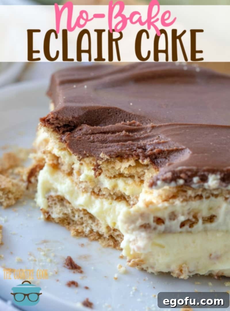 Close-up overhead photo of a slice of Eclair Cake on a white plate, with a small bite removed, showing the creamy texture and perfect layers.