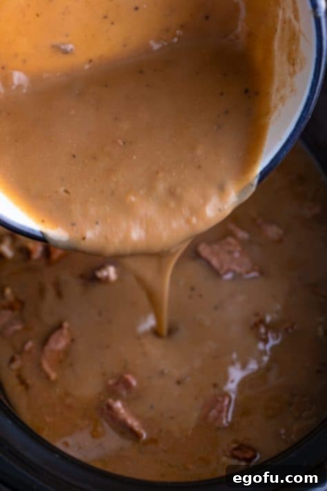 Gravy being added to the crockpot.