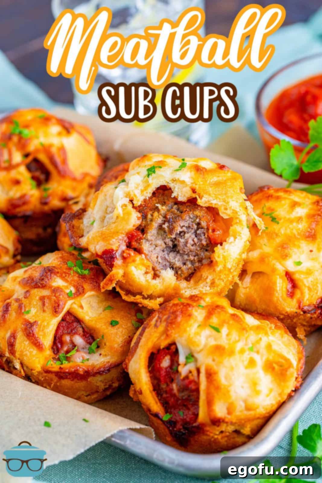 Pinterest image of Meatball Sub Cups stacked on top of one another with bite taken out of top one.