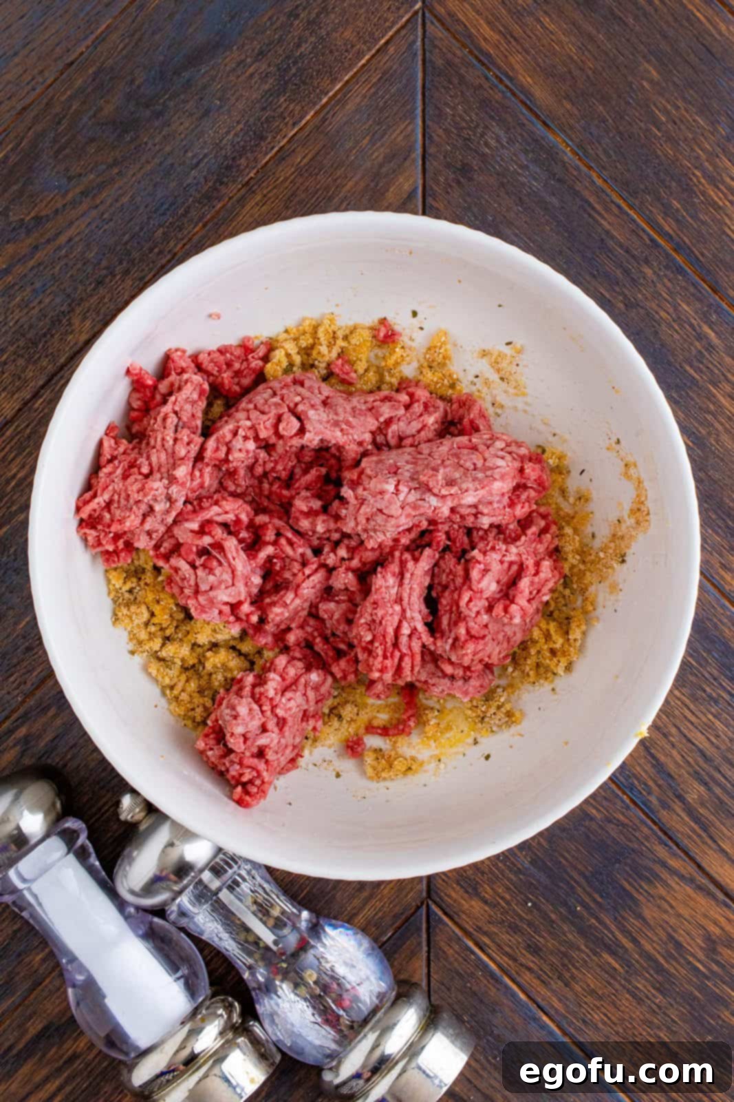 Ground beef added to mixture in bowl.