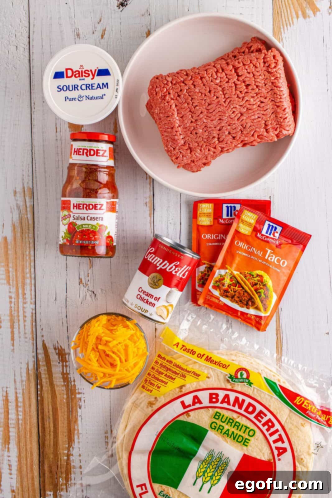 Ingredients needed: ground beef, taco seasoning, sour cream, cream of chicken soup, salsa, flour tortillas and cheddar cheese.