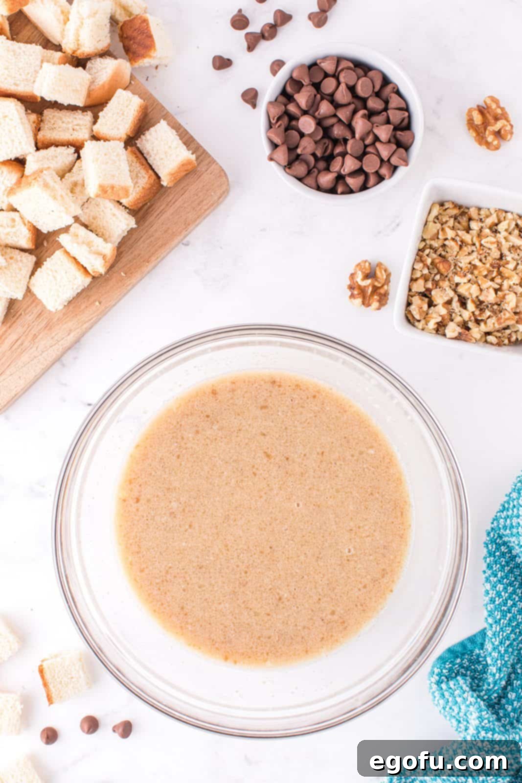 Vanilla almond milk, brown sugar, melted butter, and egg whisked together in a large bowl, creating the custard base.