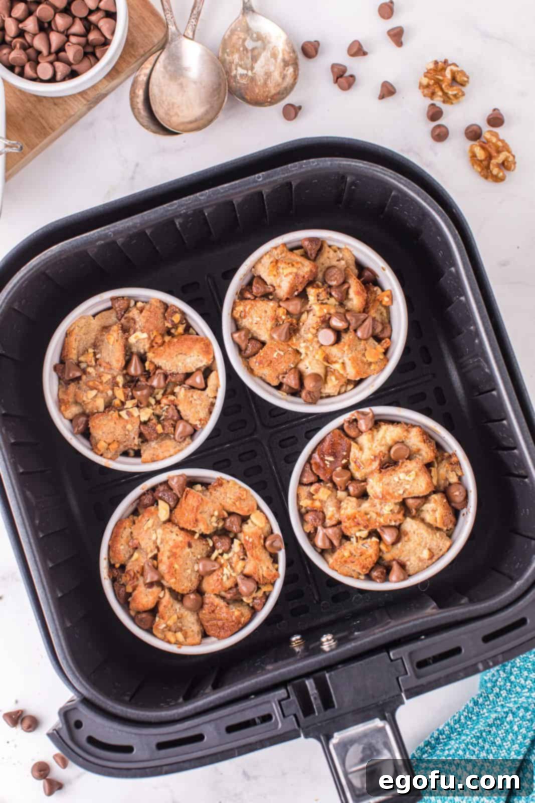 Finished, golden-brown Air Fryer Bread Pudding resting in the air fryer basket after cooking.