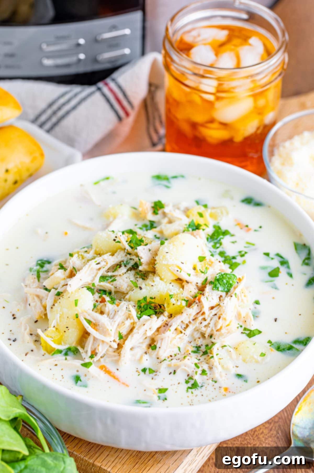 Creamy Slow Cooker Olive Garden Chicken Gnocchi Soup 2 A big bowl of Crock Pot Olive Garden Chicken Gnocchi Soup, garnished with fresh parsley.