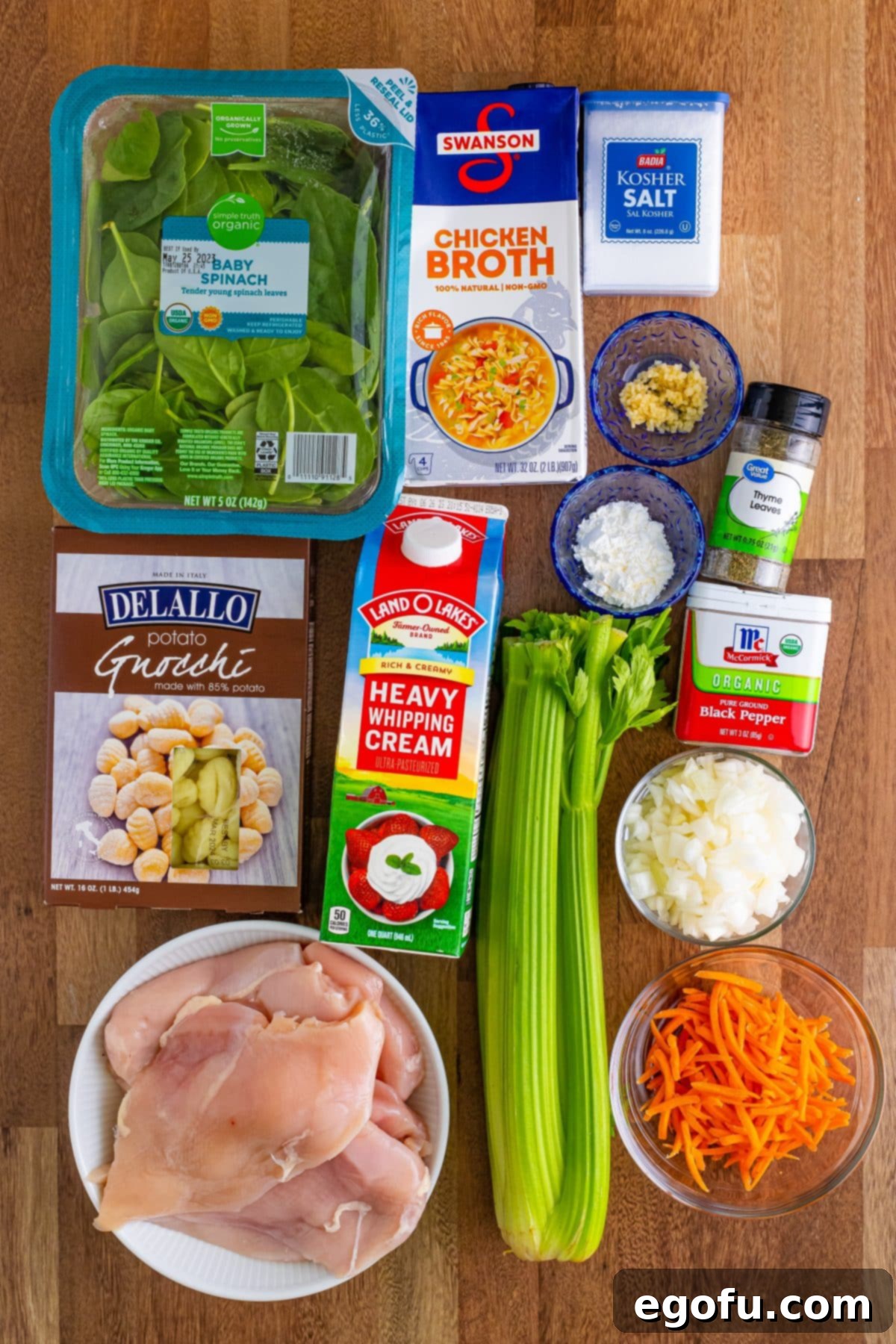 Creamy Slow Cooker Olive Garden Chicken Gnocchi Soup 5 Various ingredients for Crock Pot Chicken Gnocchi Soup including chicken breasts, yellow onion, celery, carrots, garlic, chicken broth, ground thyme, nutmeg, kosher salt, black pepper, potato gnocchi, heavy cream, cornstarch, and spinach.