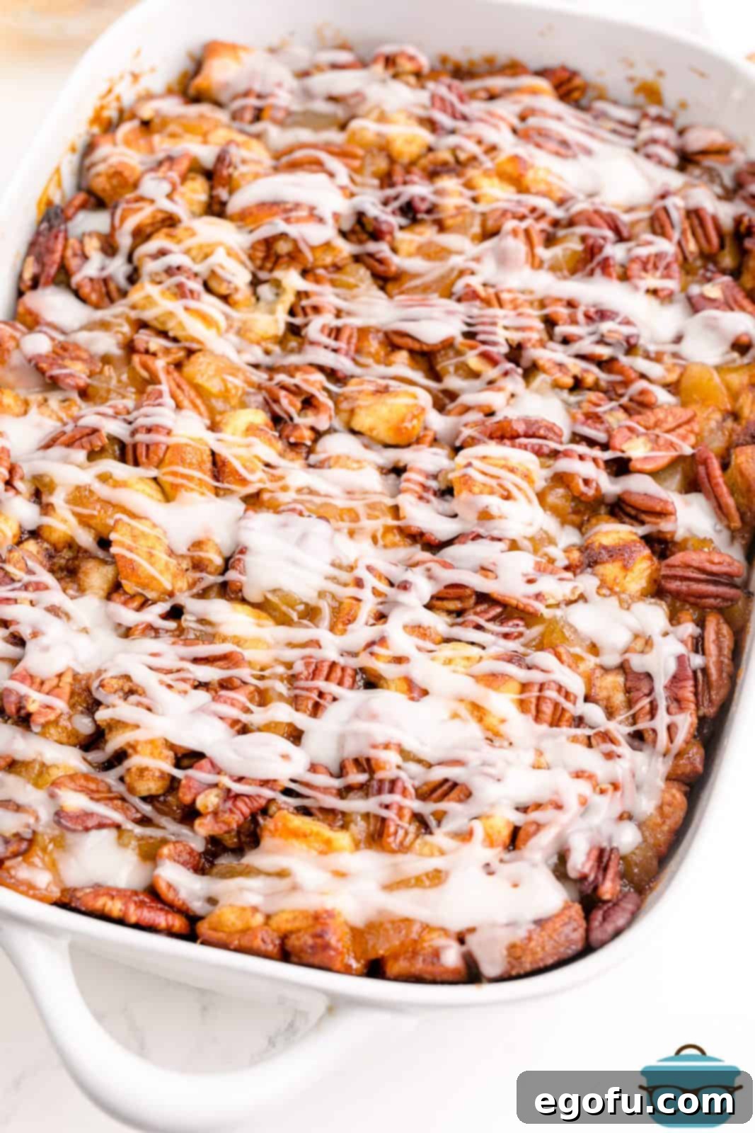 Gooey Cinnamon Roll Delight 13 Finished Cinnamon Roll Casserole drizzled with icing.