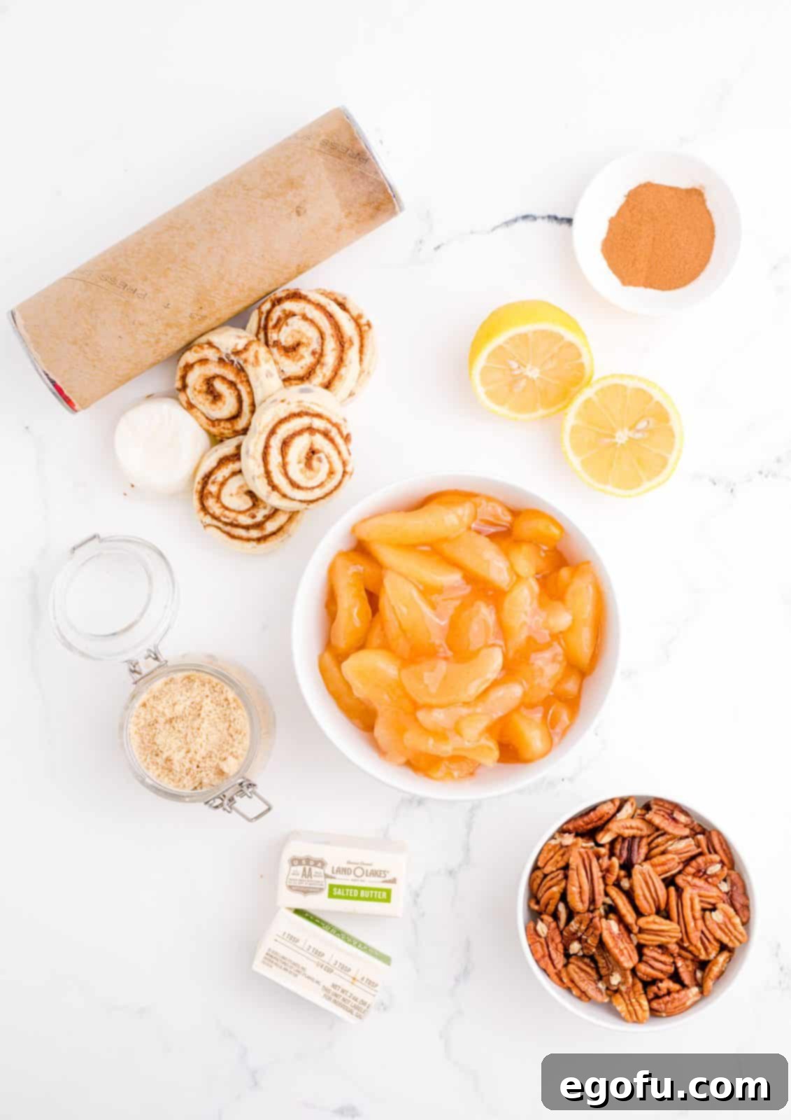 Gooey Cinnamon Roll Delight 4 Ingredients needed: refrigerated canned cinnamon rolls with icing, apple pie filling, lemon juice, butter, brown sugar, cinnamon and pecans.