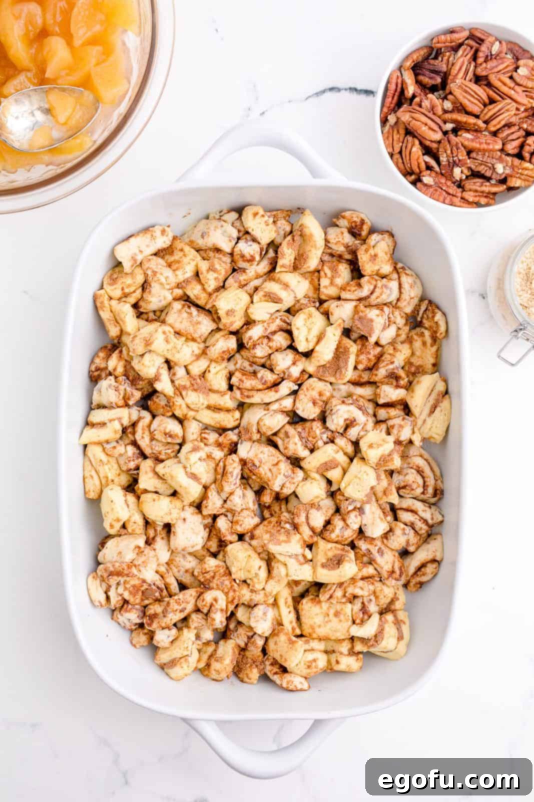 Gooey Cinnamon Roll Delight 6 Cut up cinnamon rolls placed in casserole dish.