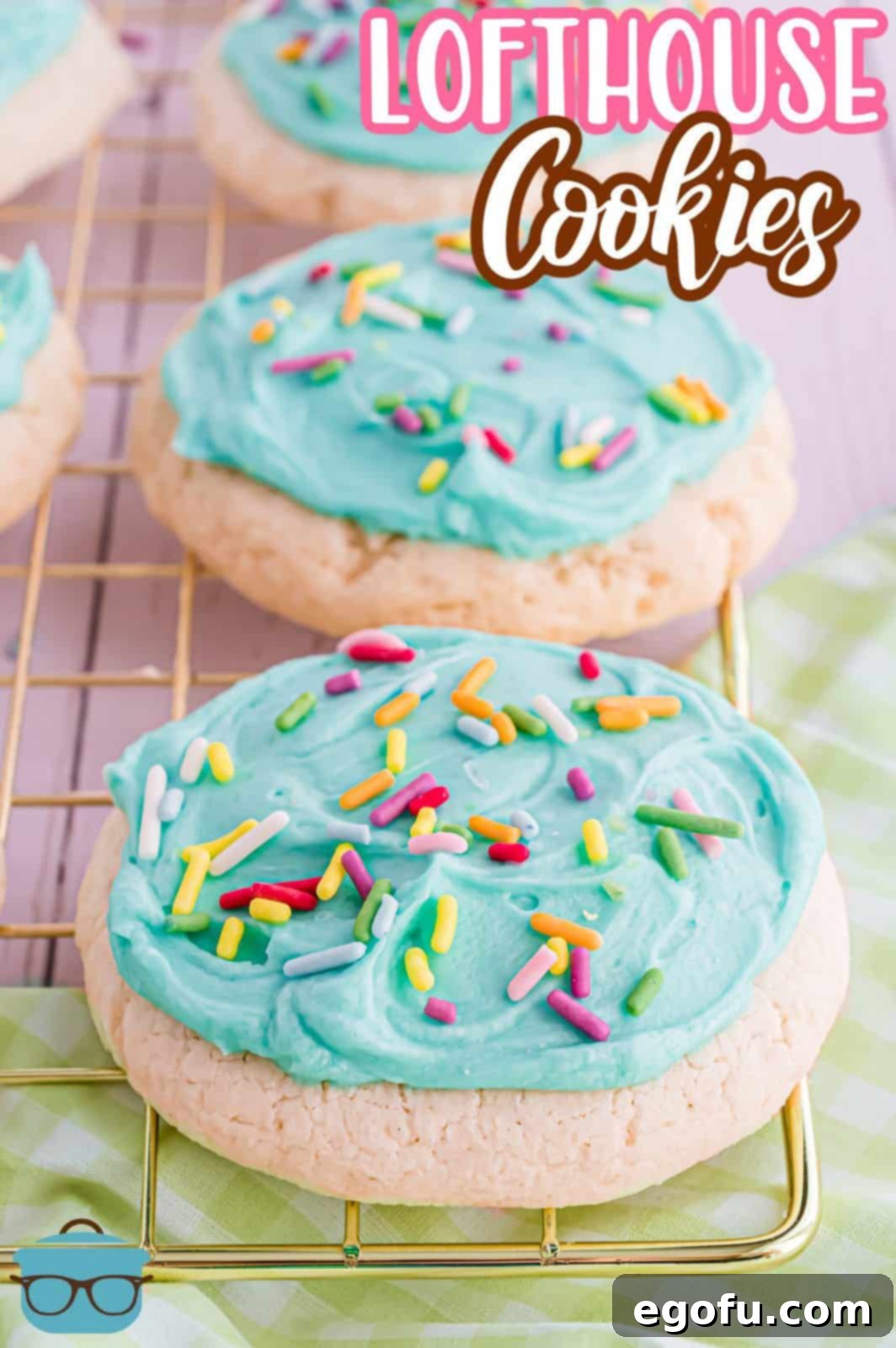 Two Copycat Lofthouse Cookies on wire rack frosted and covered in sprinkles.