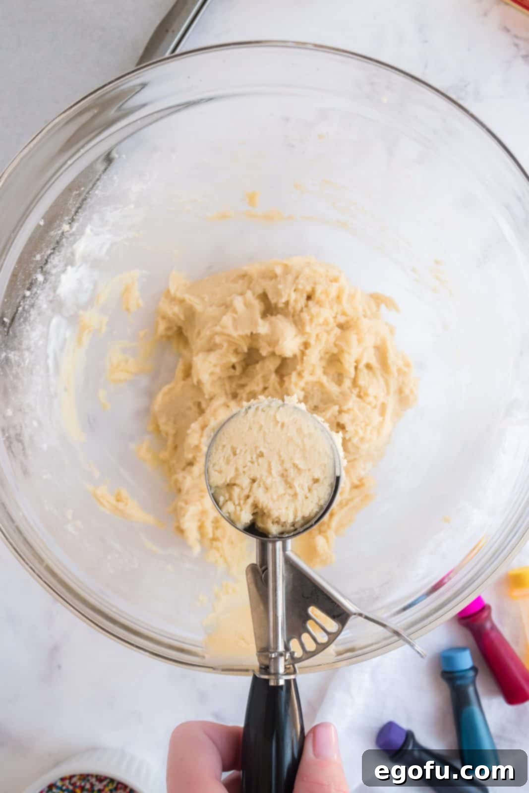 Cookie scoop scooping out cookie dough.