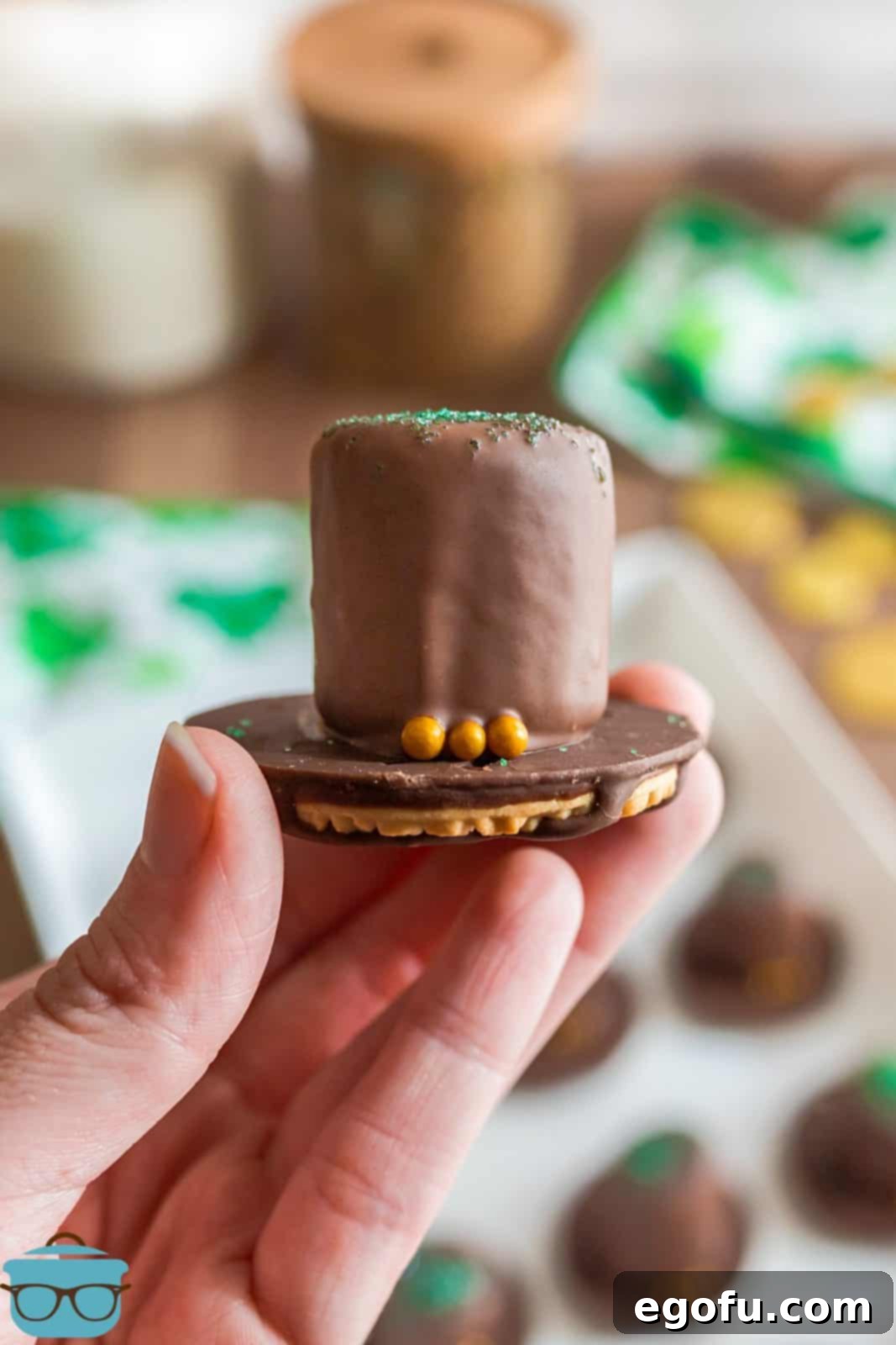 Hand holding up one St. Patrick's Day Leprechaun Hat.