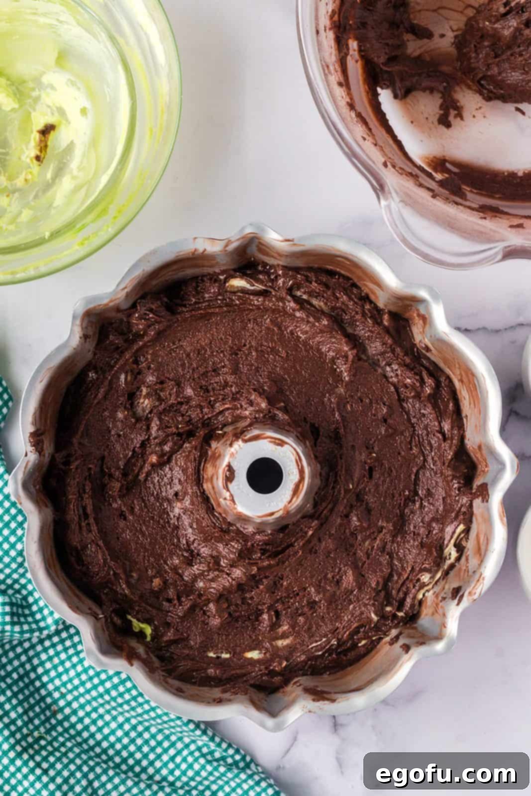 Cake batter and filling added to prepared bundt pan.