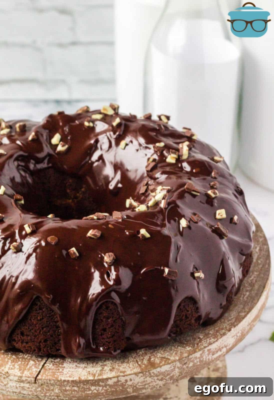 Mint Chocolate Bundt Cake covered in ganache and topped with chopped Andes mints.