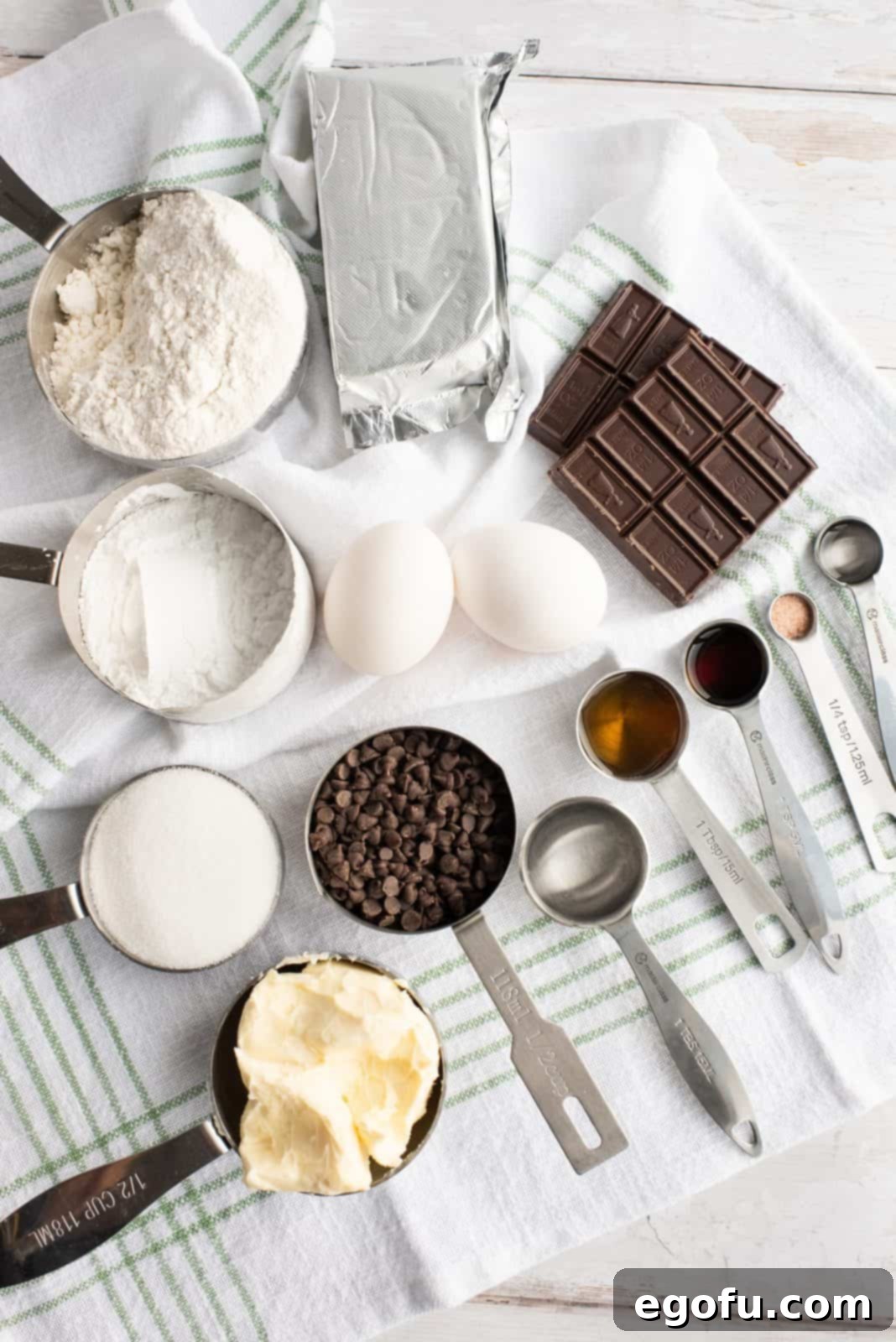 Ingredients for Mint Cream Cheese Brownies including semi-sweet chocolate, butter, sugar, vanilla, eggs, flour, salt, cream cheese, peppermint extract, food coloring, chocolate chips, corn syrup, water, and powdered sugar.