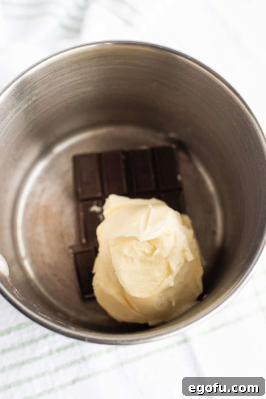 Butter and semi-sweet chocolate melting in a saucepan for the brownie base.
