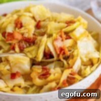 Crispy Bacon and Caramelized Cabbage 9 Square image of Bacon Fried Cabbage close up in bowl with serving spoon.