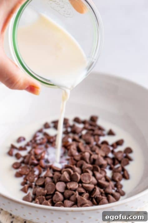 Milk being poured over chocolate chips.