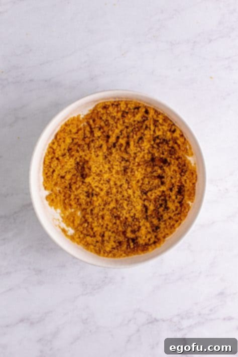 Brown sugar and vegetable oil beaten together in bowl.