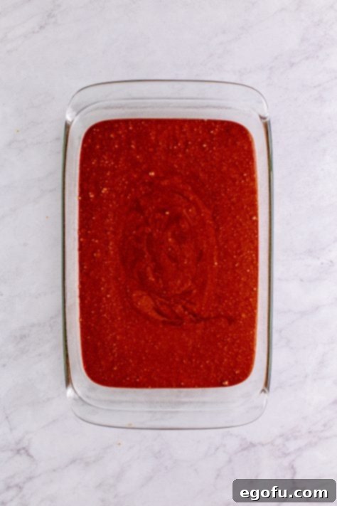 Cake batter poured into baking dish.