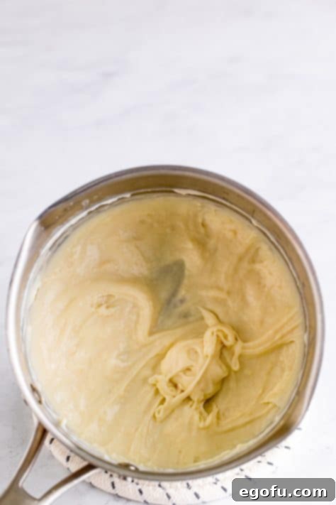 Milk and flour added to saucepan to form a paste.