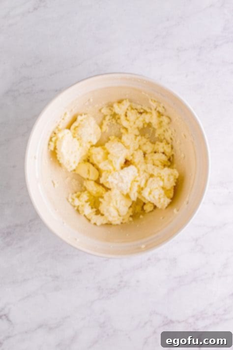 Powdered sugar added to butter and shortening mixture.