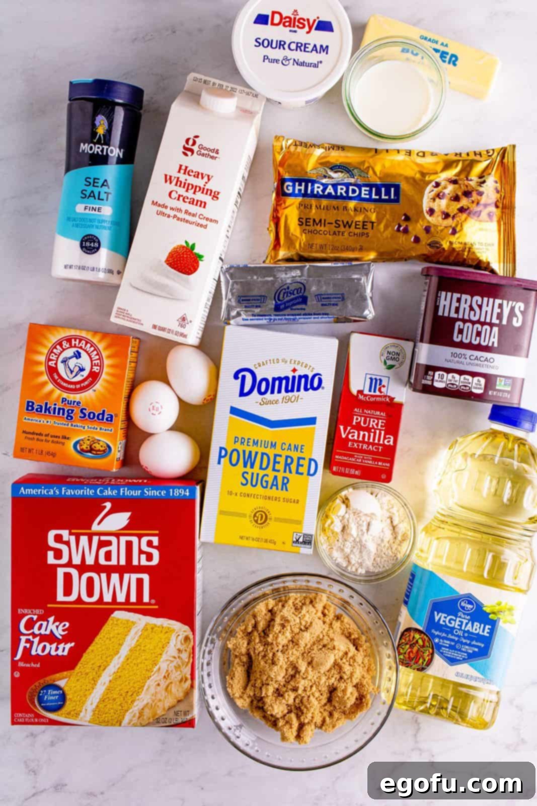 Ingredients needed: semi-sweet chocolate chips, whole milk, sour cream, cake flour, cocoa powder, baking soda, fine sea salt, light brown sugar, vegetable oil, vanilla extract, eggs, all-purpose flour, unsalted butter, vegetable shortening, powdered sugar and vanilla extract.