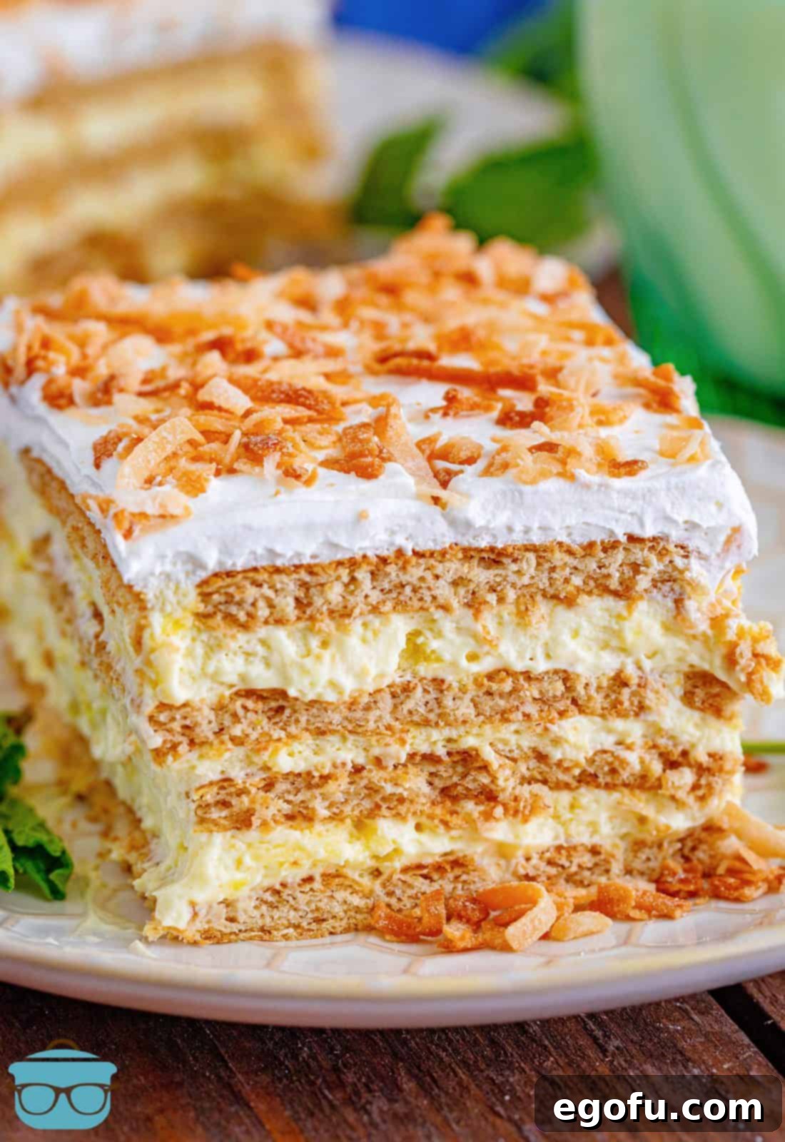 Slice of Coconut Icebox Cake on white plate.