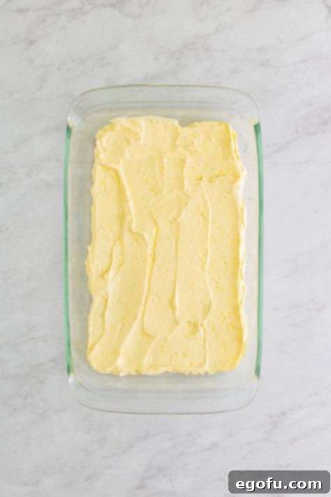 Coconut pudding mixture spread over graham crackers.