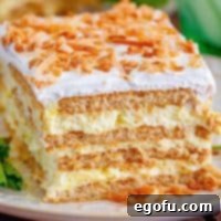 Square image close up showing layers of Coconut Icebox Cake on white plate.
