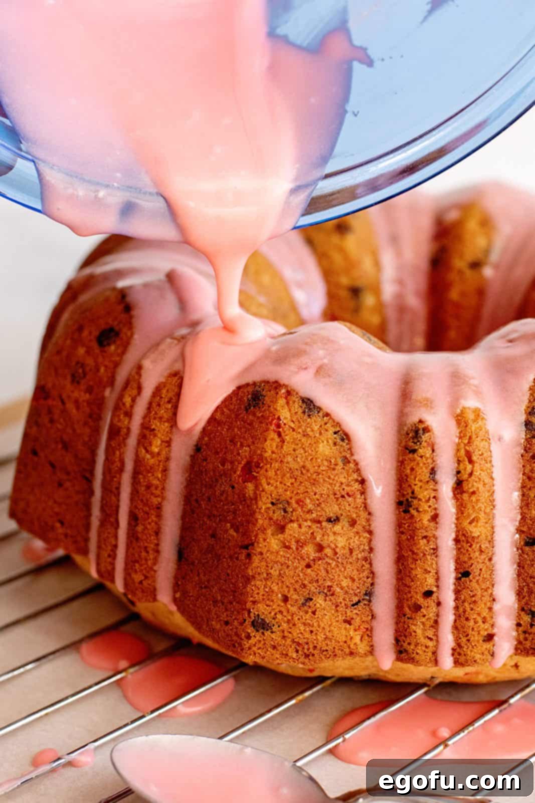 Glaze being poured over cake.