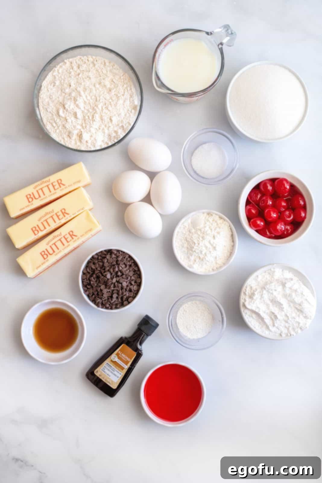 Ingredients needed: unsalted butter, granulated sugar, eggs, vanilla extract, all-purpose flour, cornstarch, baking powder, salt, milk, mini semi-sweet chocolate chips, maraschino cherries, powdered sugar maraschino cherry juice and almond extract.