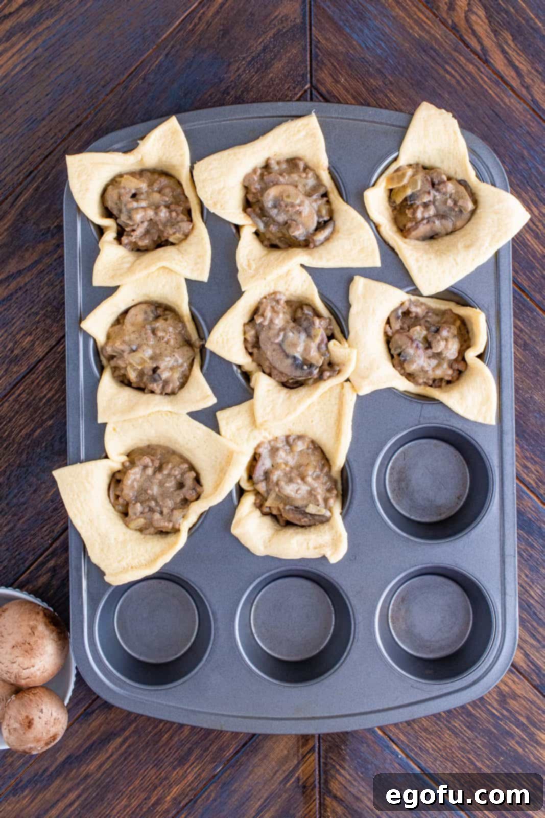 Crescent dough sheets with filling added.