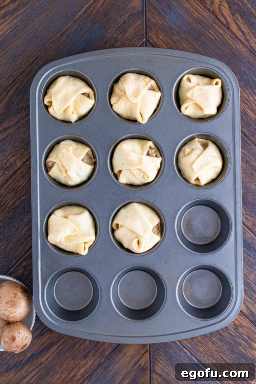 Crescent dough sheets folded over filling.