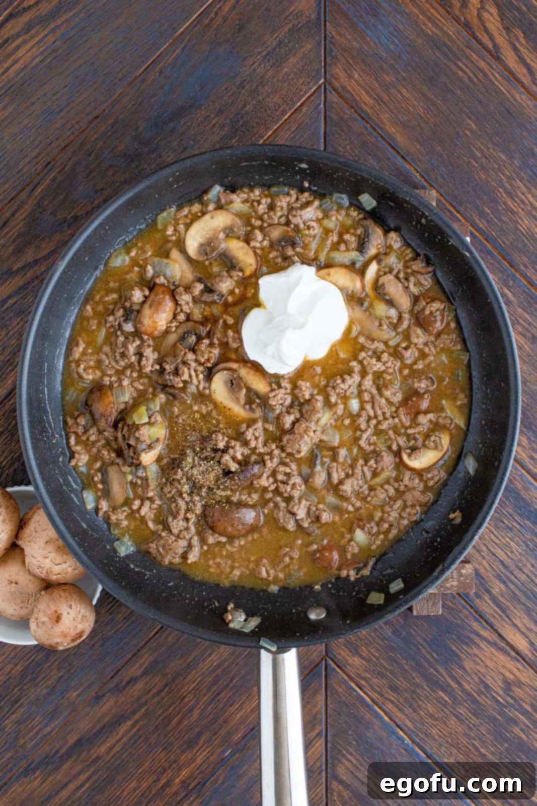 Sour cream, Worcestershire sauce, and black pepper added to ground beef mixture.