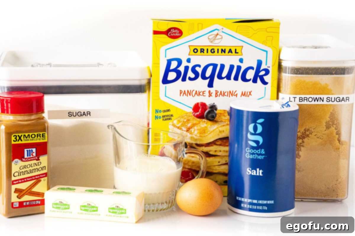 All the essential ingredients for Bisquick Coffee Cake laid out: Bisquick mix, whole milk, granulated sugar, eggs, vanilla extract, salted butter (melted), light brown sugar, and ground cinnamon.