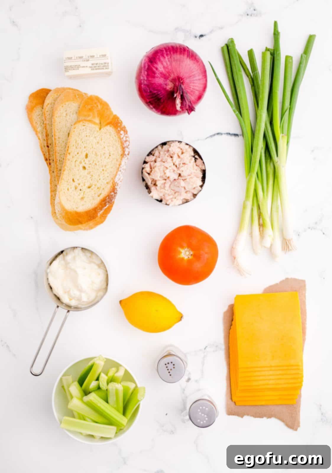 Golden Grilled Tuna Melt 4 Ingredients needed: canned tuna, mayonnaise, red onion, lemon juice, salt, pepper, celery, green onion, cheddar cheese, tomato, bread and salted butter.